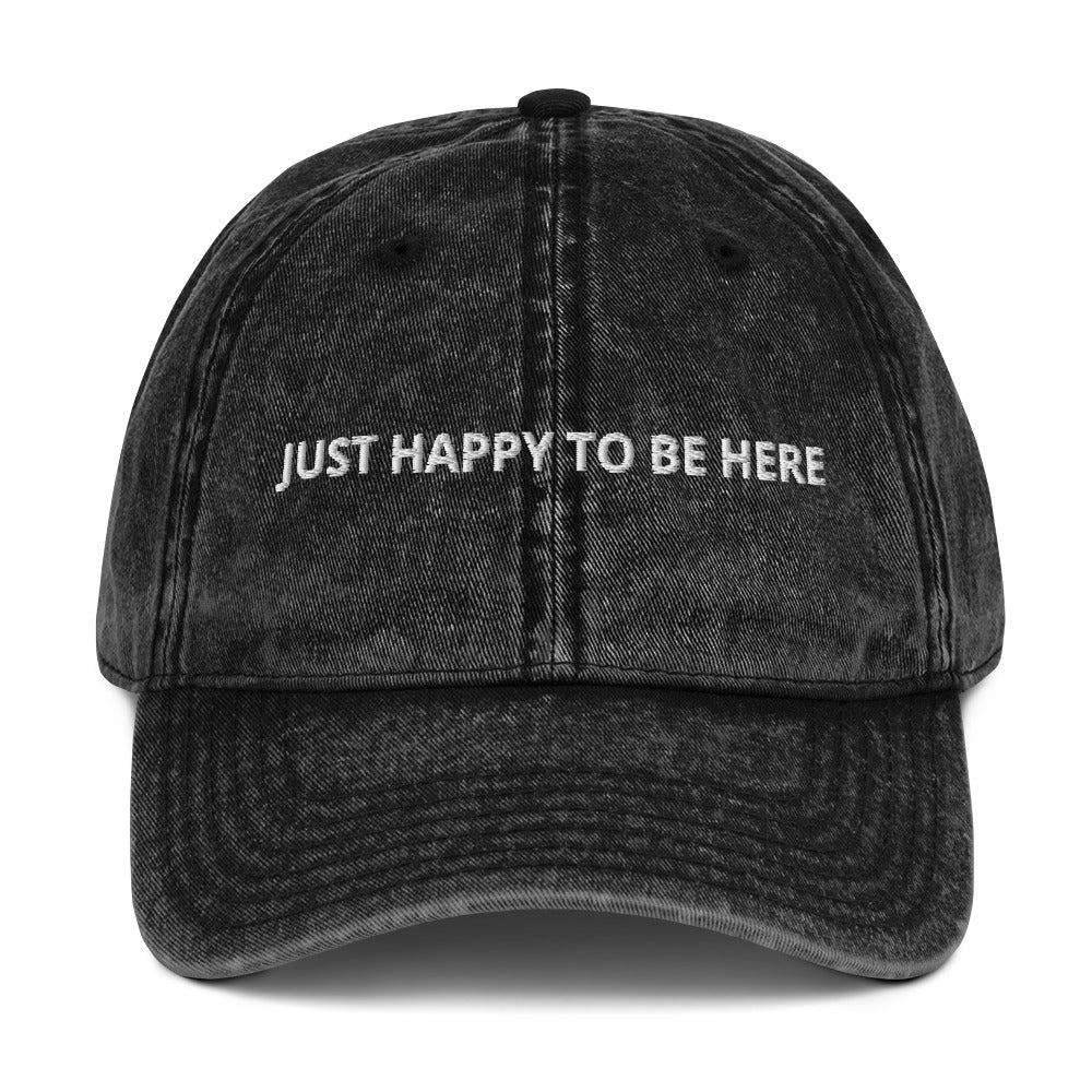 Black Our "Just Happy to Be Here" Dad Hat is comfy, adjustable, and perfect for everyday wear. Whether you’re traveling in Kazakhstan or snacking on the couch, this embroidered baseball cap adds a positive touch to any outfit. 