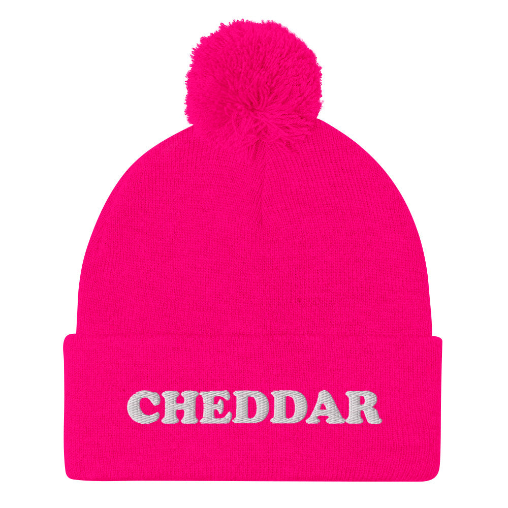 Pink Do you love cheddar cheese? Looking for a funny foodie gift? This warm and cozy, embroidered beanie is just what you need. It's a classic pom pom beanie with "Cheddar", expertly embroidered on the front. The perfect funny beanie for cheese lovers, cheddar enthusiasts and foodies of all kinds.