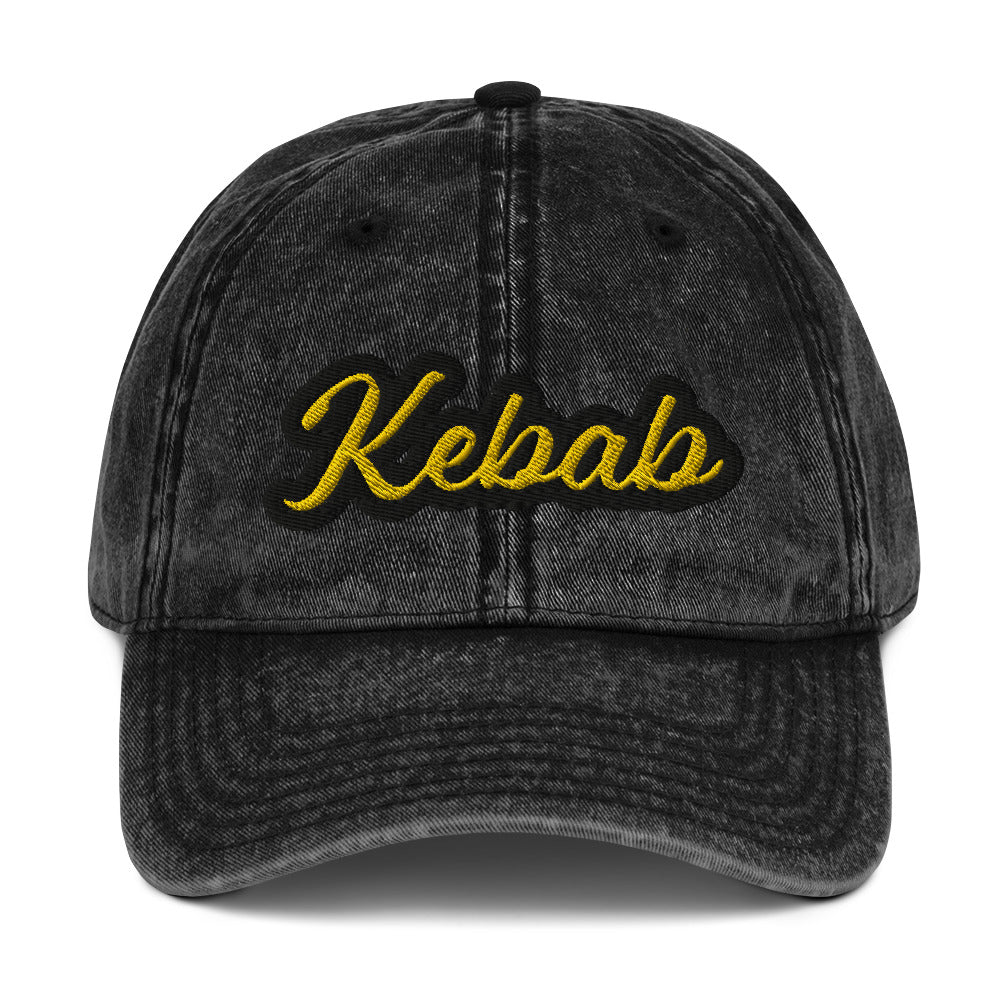 Black kebab dad hat - This kebab dad hat, made of cotton, is designed for kebab enthusiasts. The hat showcases a washed-out cotton material with vintage-style embroidery. It's the ideal funny food hat for both kebab lovers and Middle Eastern foodies. This kebab hat is a unique, statement accessory for foodies or gift for kebab aficionados. 