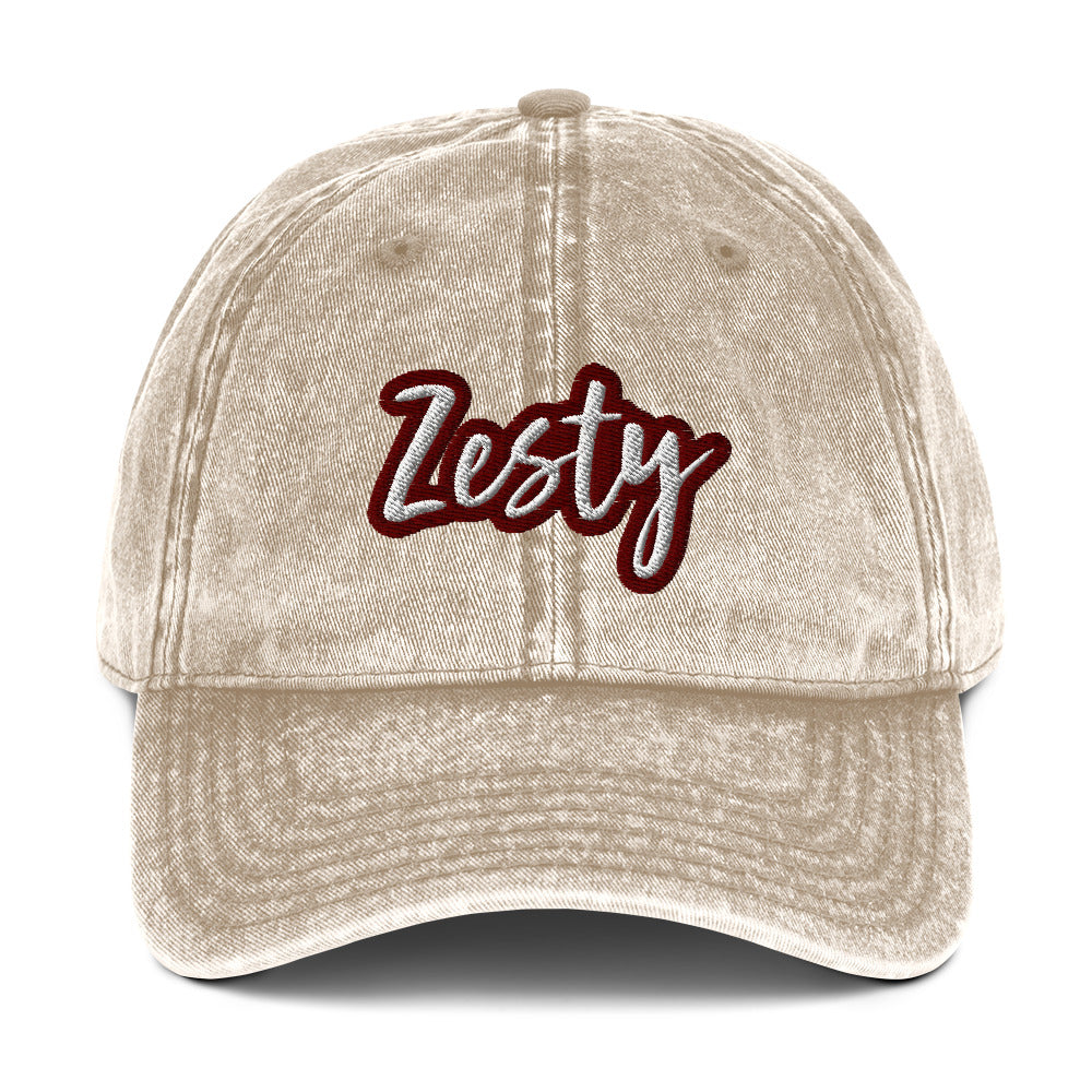Embroidered Beige Zesty hat - The Zesty Dad Hat, a perfect accessory to add a touch of personality to your outfit. With a vintage-style faded look, a red and white unique embroidery, and an adjustable strap, this quirky dad hat was made just for you. Wear this colorful dad hat as everyday wear or give this hat as a funny gift to a zesty friend.