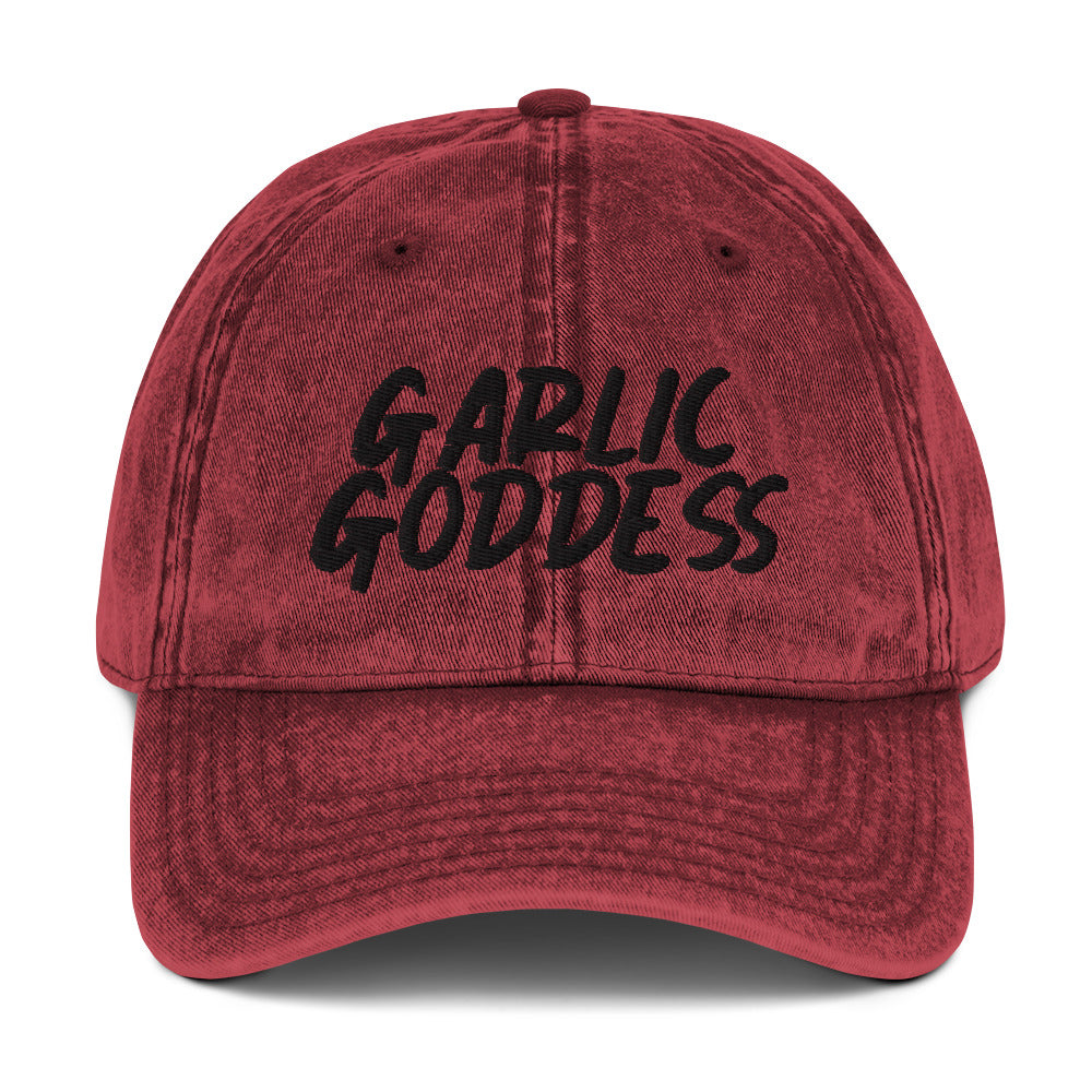 Maroon garlic goddess dad hat from Nina's Funky Shop by ninanush - This unique garlic dad hat comes in a variety of colors with Garlic Goddess on the front. Our Garlic Goddess hat was designed by Nina especially for garlic enthusiasts and foodies of all kinds. Stay funky and eat garlic in this embroidered vintage style dad hat or give it as a unique gift for a garlic lover.