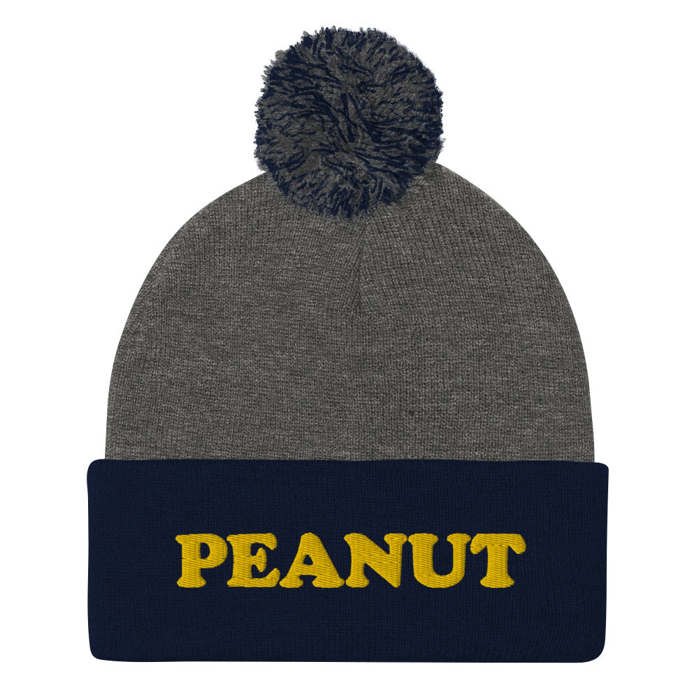 This "PEANUT" beanie hat is a perfect warm and cozy hat for cold weather. It's a classic beanie with a pom pom on top and a unique foodie embroidery. Our peanut beanie hat is part of our foodie clothing collection. Celebrate your favorite foods in our funky foodie beanies, weird hats, creative artsy hoodies, vegan tees and more
